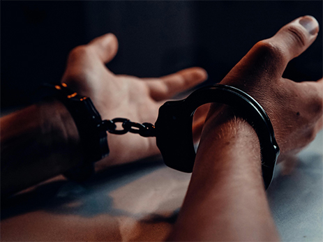 A man with both hands handcuffed